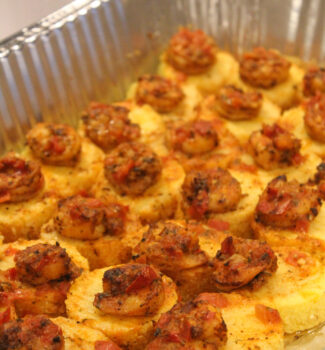 Shrimp grit cakes displayed on a platter.